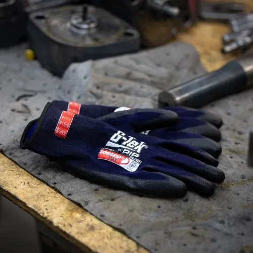 Close-up of industrial safety gloves worn by a mining worker handling equipment